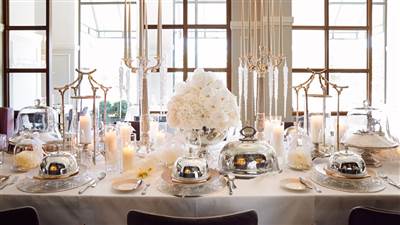 A large dining table in the hotel, neatly set and arranged