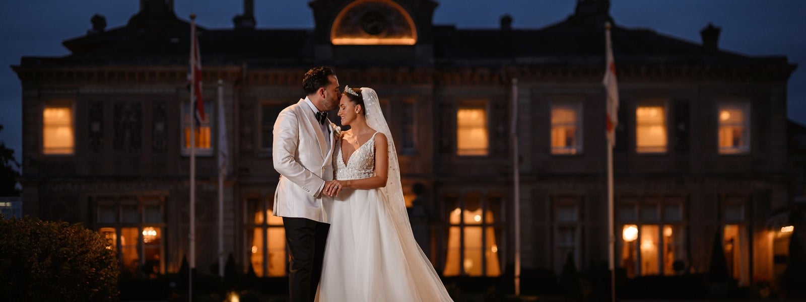 Twilight Wedding Package Essex - Groom Kissing Bride at Twilight Wedding