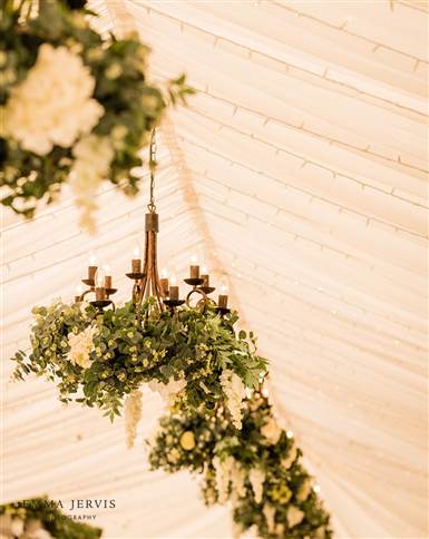 Wisteria dripped chandeliers in garden marquee