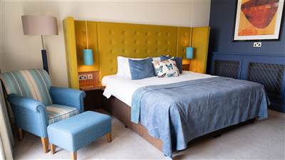 Bright and spacious guest room at The Garryvoe Hotel featuring comfortable furnishings, elegant déco