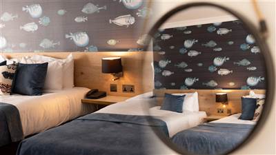Bright family guest room with three beds at The Garryvoe Hotel.