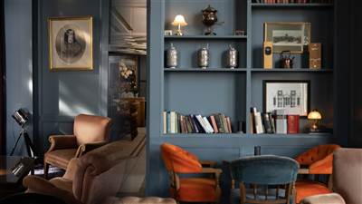 Elegant library at The Garryvoe Hotel featuring comfortable seating, warm lighting, and a cosy space