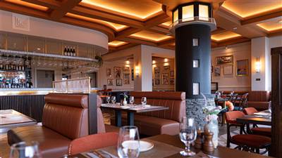 Warm and inviting interior of The Lighthouse Bistro at The Garryvoe Hotel, featuring stylish décor, 