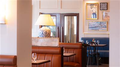 Warm booth seating inside The Lighthouse Bistro at Garryvoe Hotel
