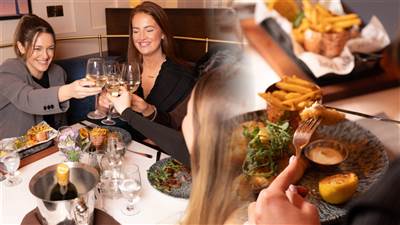 Friends enjoying food and wine together at The Lighthouse Bistro, Garryvoe Hotel.