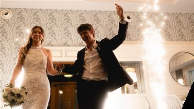 Newlyweds celebrating with indoor sparklers at their wedding reception