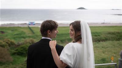 Wedding couple on the Bridal Suite balcony overlooking Ballycotton Bay