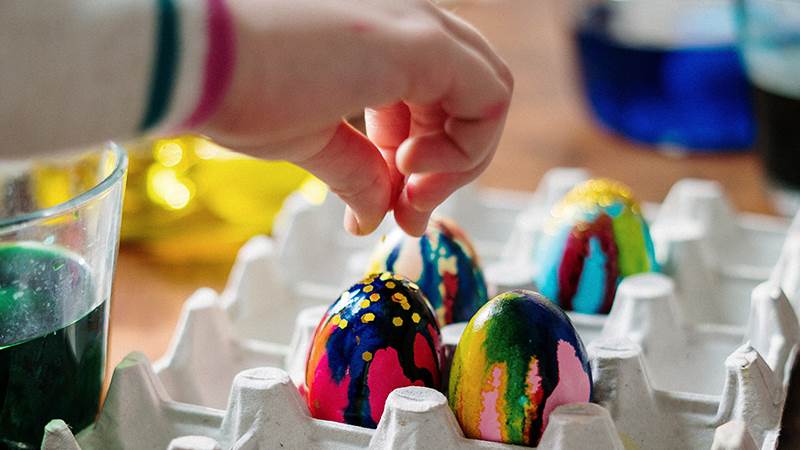 person holding easter egg on palette tra