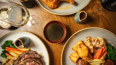 3 plates of a Sunday Roast dinner at The London Pub