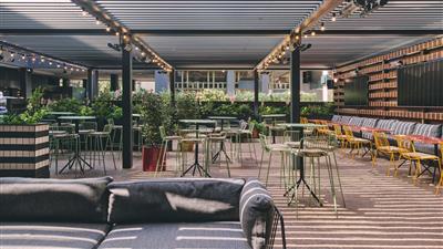 Snapshot of the Outdoor area with couches and chairs at The London Pub