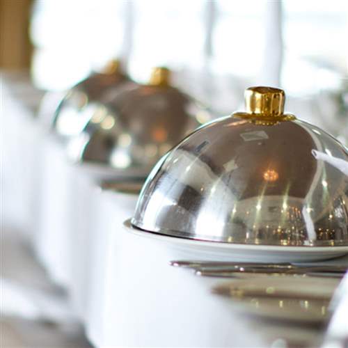 Dining trays covered with silver rounded cap