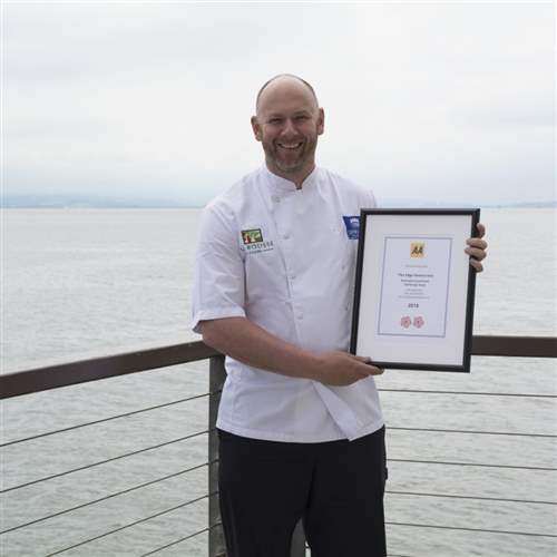 Our cook holding an AA award