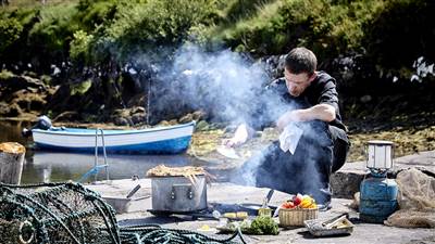 Man Cooking Food in Nature Beside the Lake - Things to Do in Kerry
